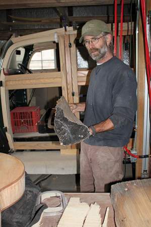 Don Wilson and a chunk of red spruce that will become a guitar top. 