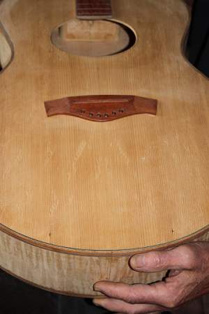 Red spruce top, curly maple body. Note bear claw figure. 